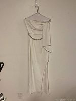 Full view of white strapless dress on hanger