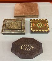 Four closed boxes showing exterior designs and finishes