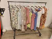Rack displaying ten dresses on hangers