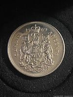 Reverse side showing Canadian Coat of Arms and legends