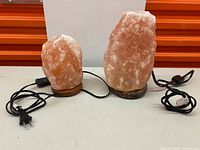 Both Himalayan salt lamps side by side showing size difference and cords
