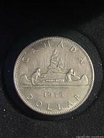 Reverse: Voyageur canoe scene with date 1975 and CANADA DOLLAR legend