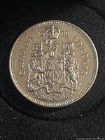 Reverse of 1976 Canadian 50-cent coin showing Coat of Arms and denomination