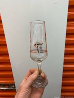 Champagne flute front view showing Torch Relay emblem and gold band