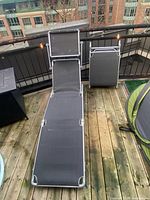 One lounge unfolded showing frame, fabric seat, sunshade