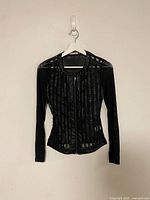 Full front view of black mesh stripe jacket on hanger