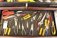 Full drawer of assorted pliers, grips, cutters, scissors, adjustable wrench, and a tape measure.