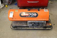 Dyna-Glo Pro orange kerosene heater with 80,000 BTU label visible on side.