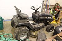 Side view of entire riding mower showing black Murray Select body, seat, steering wheel and rear tires