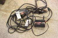 Overview of booster cables coiled with clamps and the 400W electrical outlet unit attached by cables.