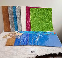 Overall lot showing glitter sheets, cork tiles, sealed magnet sheets, embellishment packs