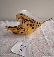 Side view showing overall shell shape and mottled amber glass