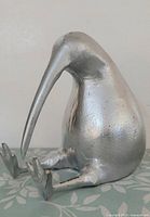 front-left view of silver cast metal kiwi figurine