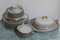 Full set stacked showing plates, teacup, covered vegetable dish on underplate