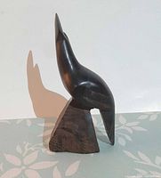 Front-left view of ironwood quail figurine showing overall shape and base