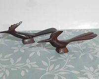 Both ironwood roadrunner sculptures side by side