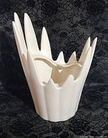 Front view of off-white spiked crown vase