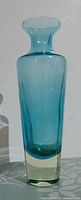 Front view of blue-green uranium glass vase showing overall form and clarity