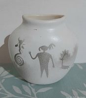 Front view showing pictograph figures and rounded form