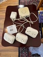 Overall lot showing Hue Bridge, power adapter, three Sylvania smart plugs