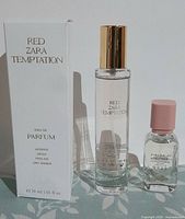 Front view showing both fragrance bottles and Red Temptation box