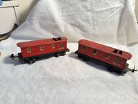Two red Lionel 1682 cabooses side by side showing general condition