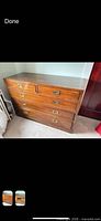 Front view of Ethan Allen four-drawer wood dresser with brass recessed pulls
