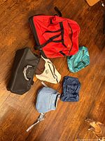 Six bags laid out on wooden floor