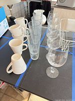 Group view of mugs, tumblers, and wine goblets