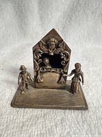Front view of entire silver miniature puppet theatre with two figures