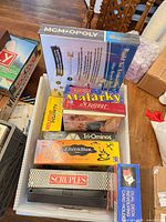 Overview of plastic bin showing all boxed games