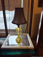 Full view of yellow glass electric lamp with shade