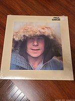 Front jacket sealed in shrink wrap showing Paul Simon portrait