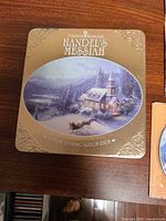 Front of gold tin showing title and artwork
