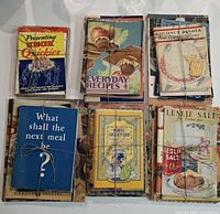 Six tied stacks of vintage recipe pamphlets, various titles visible