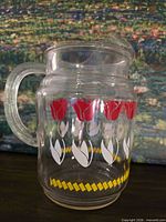 Left-angle view showing tulip pattern, handle, chipped spout