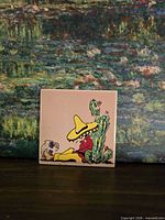 Front view of glazed ceramic tile with cartoon sombrero design