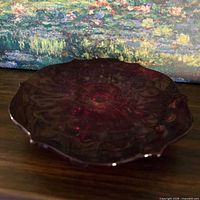 Top view showing cranberry pressed glass pattern and color