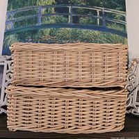two natural wicker baskets stacked, showing exterior weave pattern
