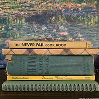 Stack of five cookbooks showing spines