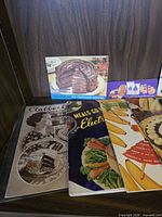 Front view showing Clabber Girl, Meals Go Modern, banana and chocolate cake pamphlets