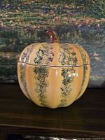 Front view of Roberts Company glazed ceramic pumpkin jar with lid