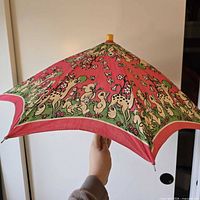 Umbrella closed, showing canopy print and finial