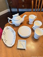 Group view of all 10 white porcelain pieces on table