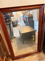 Front view of mirror showing frame finish and glass condition