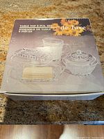 Box top showing product image and "de luxe" marking