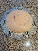 Top view showing wooden board seated inside decorative metal tray