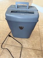 Full view of gray INIT NT-PS10GC shredder with power cord
