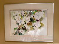 Framed watercolor floral painting in metal frame with mat