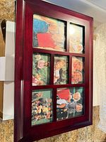 Front view of collage frame showing nine photo openings with sample images